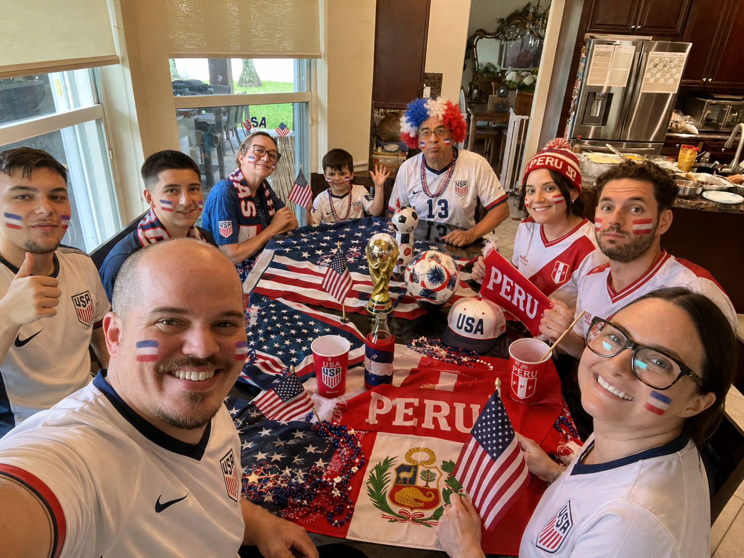 Family gathered around a World Cup watch party table with USA and Peru decorations
